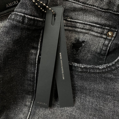 AMIRI VARSITY LOGO REPAIR JEANS