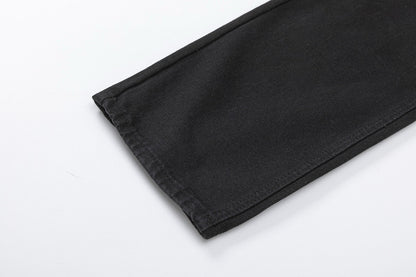 Jean noir à double croix et cœurs chromés