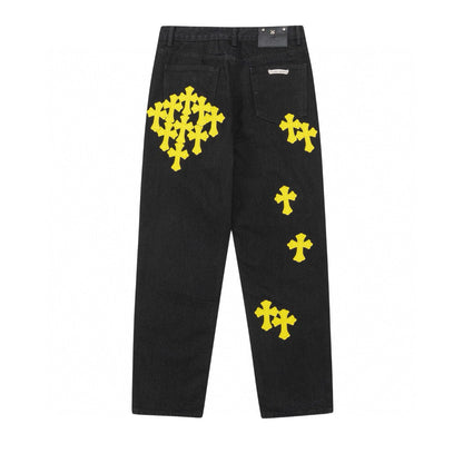Jean noir à motif cœurs chromés et croix jaune